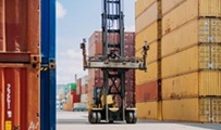 Loading containers for transport in the port with a crane